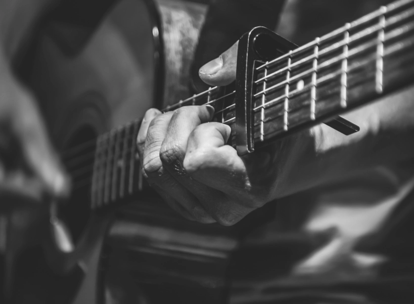 man-plays-acoustic-guitar-closeup